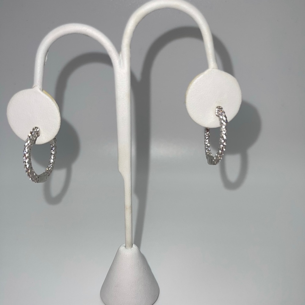 Women’s silver diamond studded hoops.
